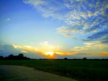 Scenic view of field against sky during sunset