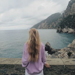 Rear view of woman looking at sea against sky