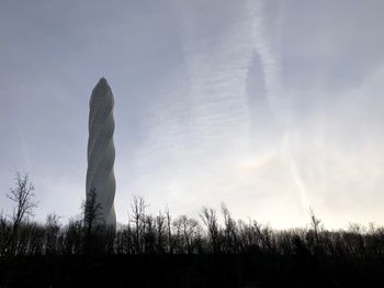 Low angle view of silhouette trees on field against sky