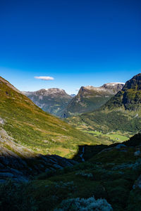 Scenic view of mountains against clear blue sky