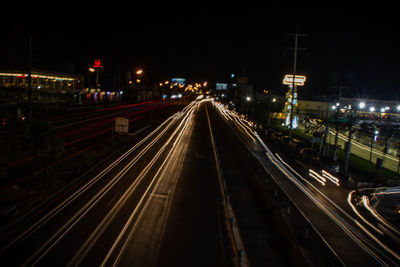High angle view of light trails on railroad tracks at night