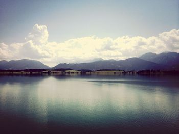 Scenic view of lake against cloudy sky