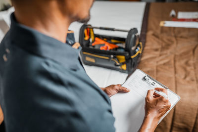 Midsection of man working on paper