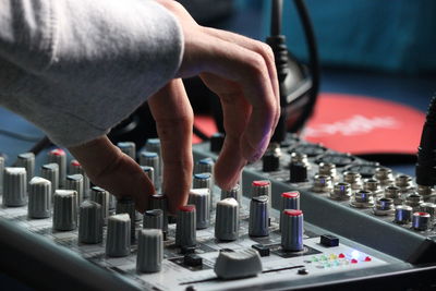 Close-up of hand using sound mixer