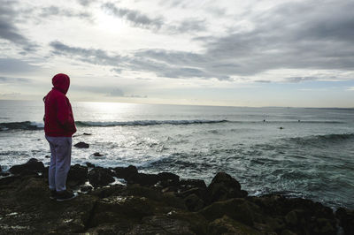 Man looking at sea against sky