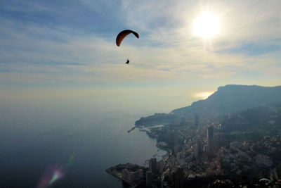 Distant view of person paragliding against sky