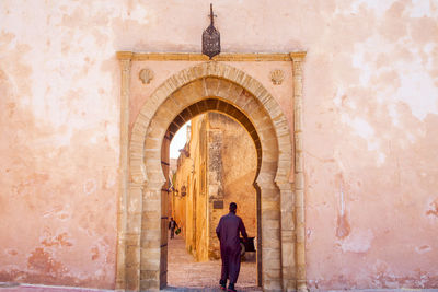 Rear view of man walking in building