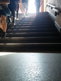 Low section of people walking on stairs