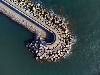 Aerial view of cement blocks protecting the shore from the waves in the port of luanco in asturias,.