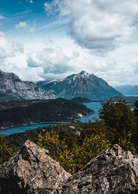 Scenic view of river amidst mountains against sky