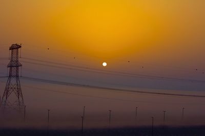 Scenic view of silhouette landscape against orange sky