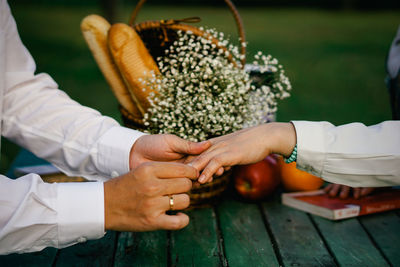 Close-up of man proposing woman over table