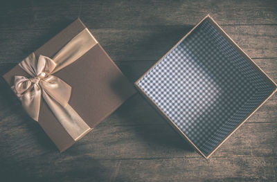 High angle view of empty gift box on wooden table