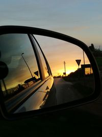 Reflection of sky on side-view mirror of car