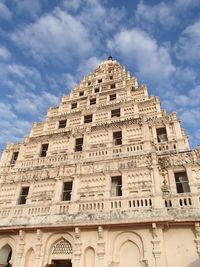 Low angle view of historical building against cloudy sky