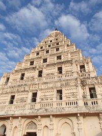 Low angle view of historical building against cloudy sky