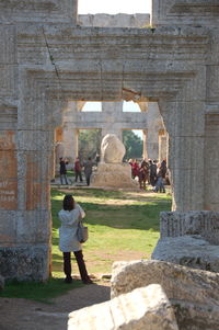 Rear view of people at historical building