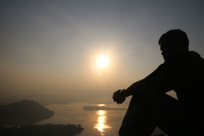 Silhouette man against sky during sunset