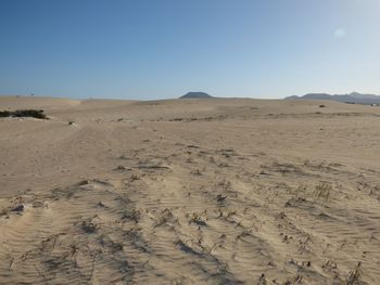 Scenic view of desert against clear sky