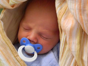 High angle view of cute baby girl sleeping on bed