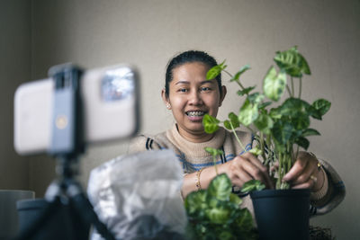 Woman vlogging about potted plants