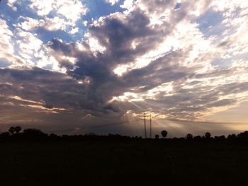 Scenic view of silhouette field against sky during sunset