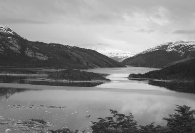 Scenic view of lake and mountains against sky