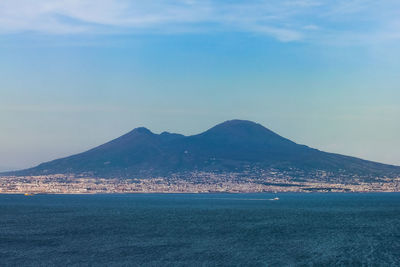 Scenic view of sea and mountains against sky