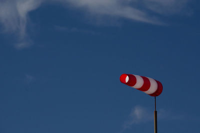 Low angle view of flag against blue sky