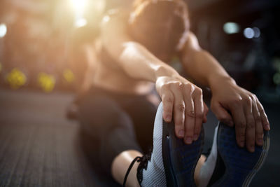 Midsection of woman sitting on floor