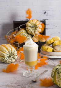 Pumpkin cinnabons and latte for dessert, holiday table with pastries, home sweet