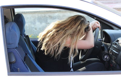 Portrait of woman sitting in car