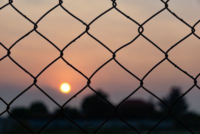 Full frame shot of chainlink fence during sunset