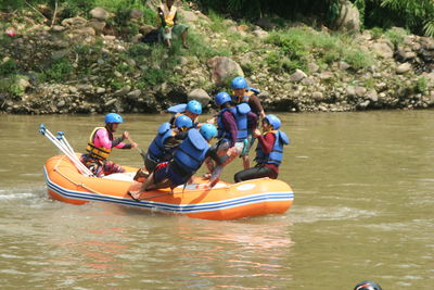 People in boat on river