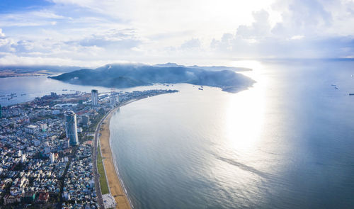 High angle view of sea and buildings against sky