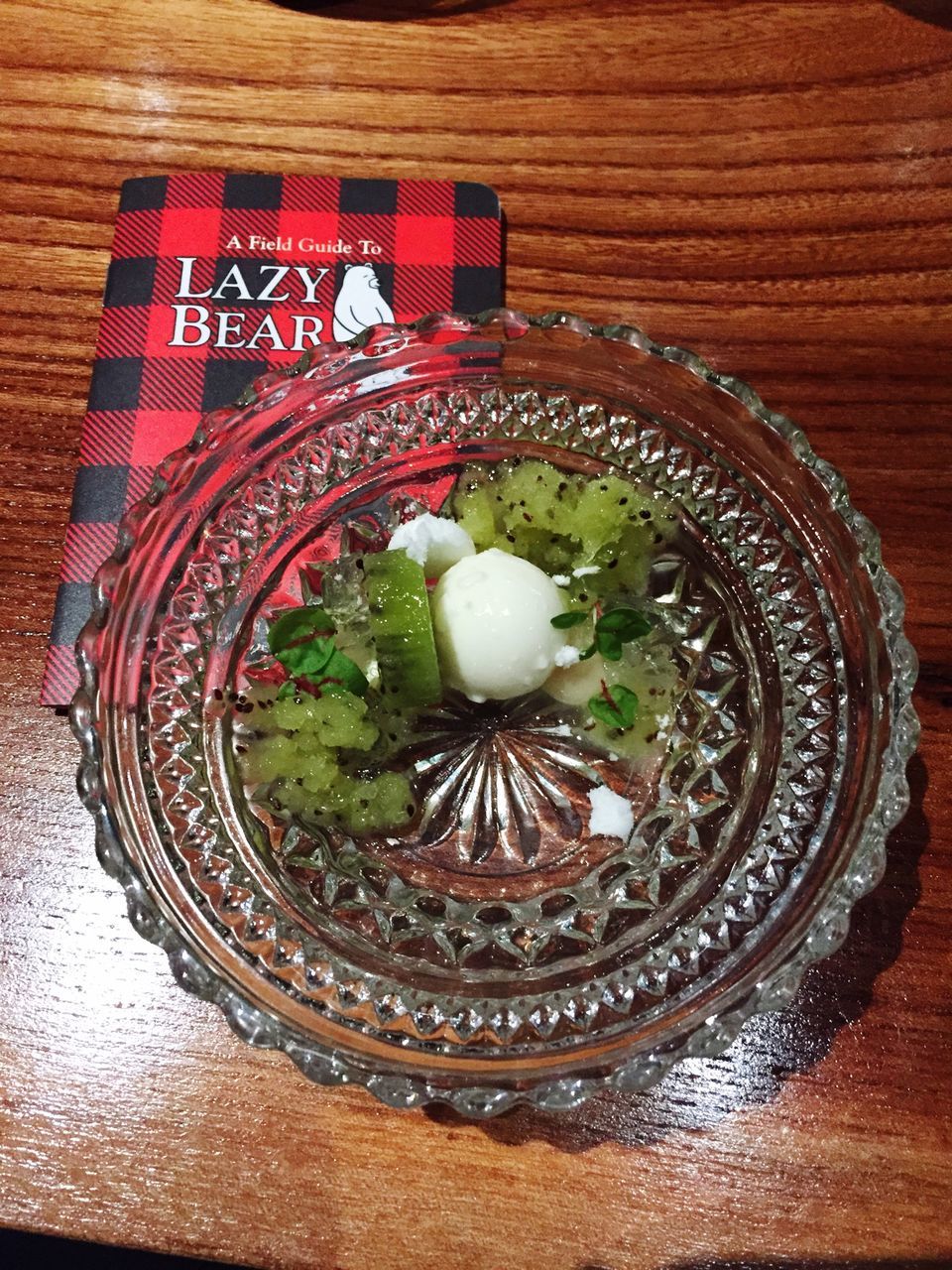 indoors, table, freshness, high angle view, still life, directly above, close-up, food and drink, food, green color, circle, wood - material, no people, decoration, leaf, red, plate, text, fruit, healthy eating