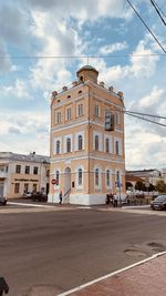 Street by building in city against sky