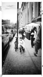 People walking on sidewalk in city