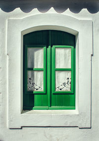 Closed green window of house