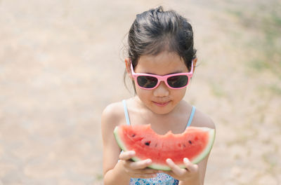 High angle view of cute girl holding watermelon