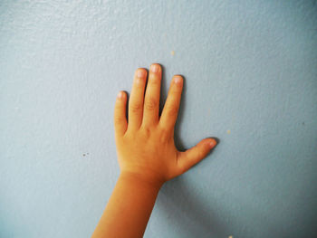 Close-up of hand on wall