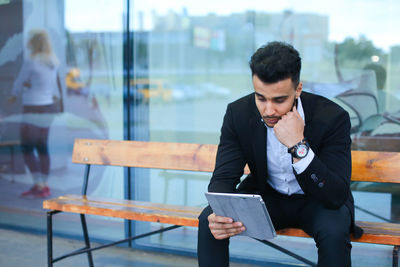 Young businessman looking at digital tablet
