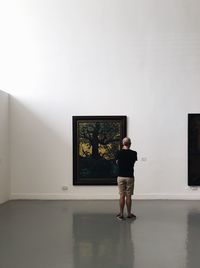 Man standing in front of museum