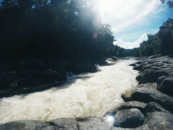 Scenic view of waterfall against sky