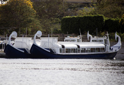 Side view of boats moored in water