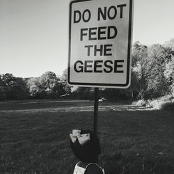 Low section of man with text on road