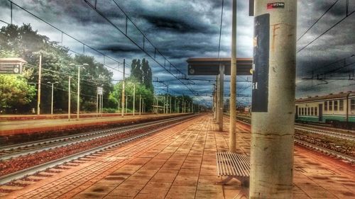 View of railroad tracks against cloudy sky