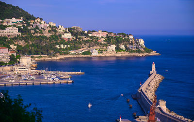 Panoramic view of sea and townscape against sky