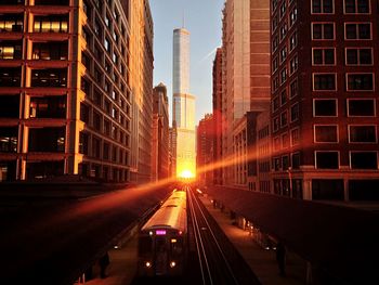 Train passing through city at dusk