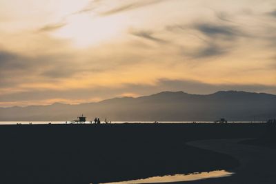 Scenic view of silhouette mountains against sky during sunset